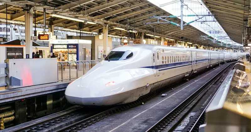 Shinkansen bullet train arriving at a station platform