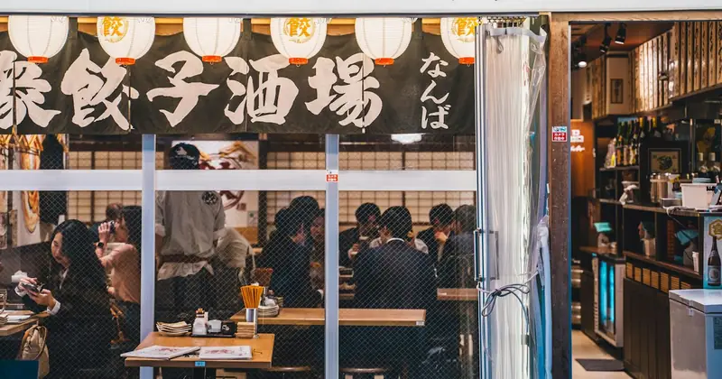 Diners inside a busy Japanese izakaya restaurant