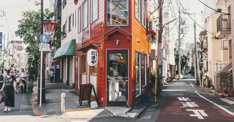 Quiet residential street in Tokyo with a small red corner shop